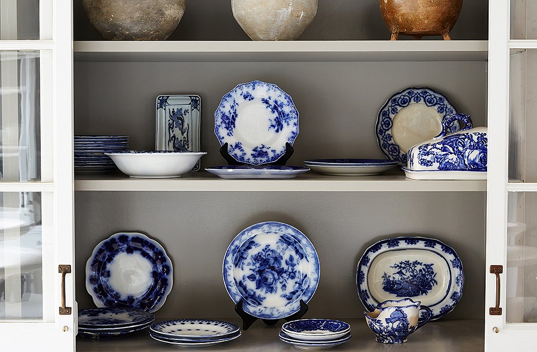 A display cabinet showcases flow blue china that Darryl has collected over the years. Most of the pieces are hundreds of years old and originated in England, Prussia, and China.
