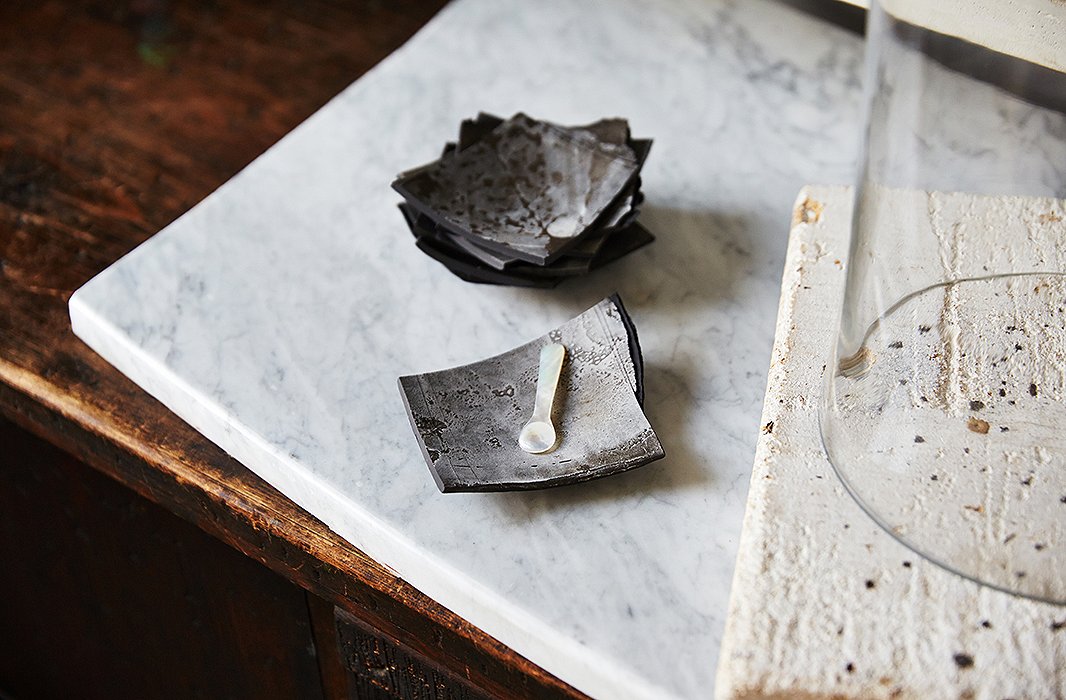 A delicate mother-of-pearl spoon is placed with one-of-a-kind salt cellars designed by one of Darryl’s friends, local artist Margaret Boozer. “Margaret works in all earthen materials, and this clay in particular was dug up from the ground around Washington D.C.,” Darryl explains. “No two [pieces] are the same.”
