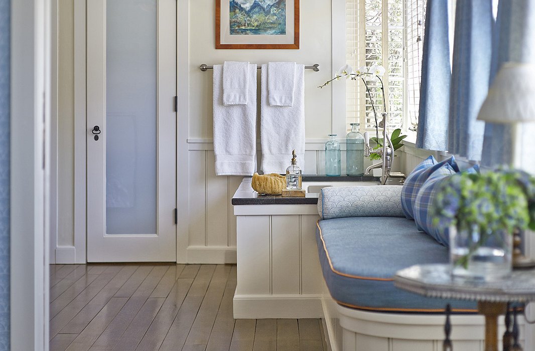 The bathroom at Hillside beckons with a dreamy blue palette and an even dreamier tub.
