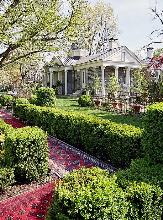 Vintage runners are rolled out along garden paths.
