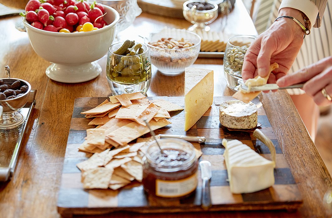 A simple cheese spread on a checkered wood board makes for a character-filled display.
