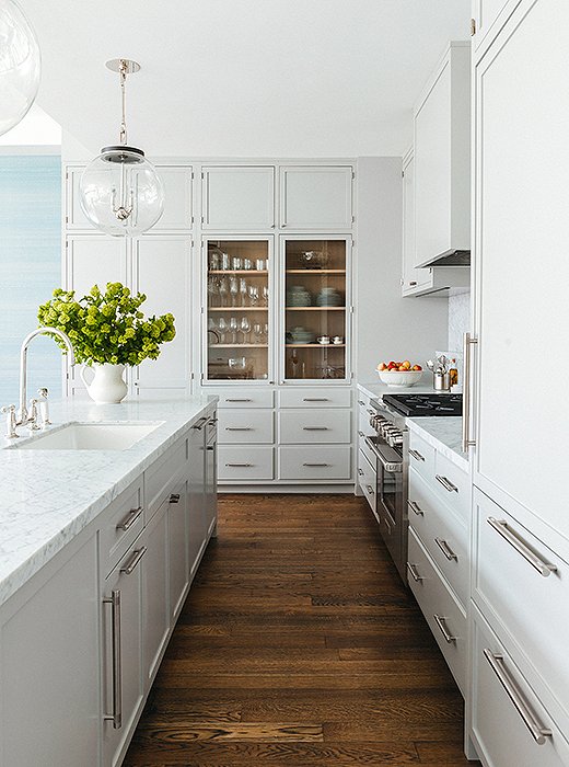 The McGraths mixed open and closed storage in the kitchen for a clean and composed look. Cabinets in Benjamin Moore’s Cliffside Gray.
