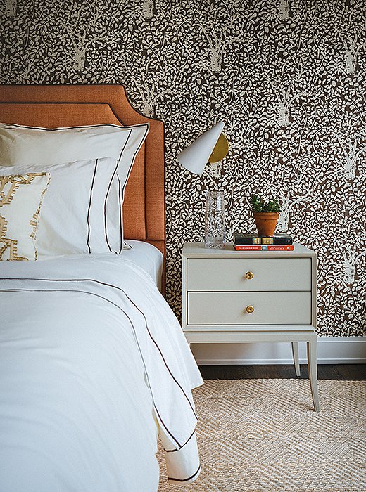 Statement wallpaper turns the loft’s guest bedroom into a cozy retreat.
