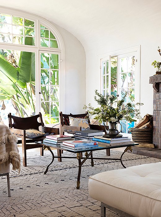 A glass-and-iron coffee table holds part of Heidi’s library of art and fashion books. “My grandmother was a painter, so she had really beautiful museum books that I still have.” The leather armchairs are by an L.A. designer.
