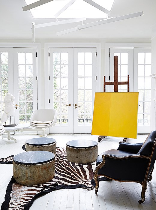 Darryl’s guest sitting room is home to a chair set plucked from what once was “a midcentury L-shape airport sofa,” which he wholly reinvented—from orange vinyl and a chrome base to kidskin and white powder coat.
