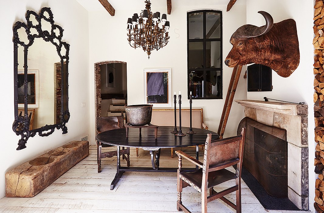 In the lower family room, an antique African water-buffalo head and a 19th-century ladder bought at a Paris flea market are conversation starters. Most of the floors in the home—including these—are the original oak.
