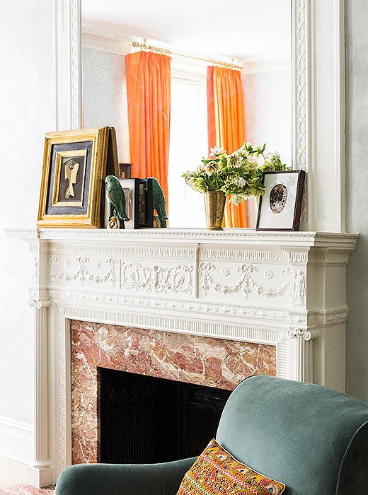 Color is a constant in Roberta’s Upper West Side apartment. Case in point: A glimpse of vibrant silk curtains (one of several sets Roberta unearthed at a Bangkok market) enlivens a neutral vignette atop the living room mantel.
