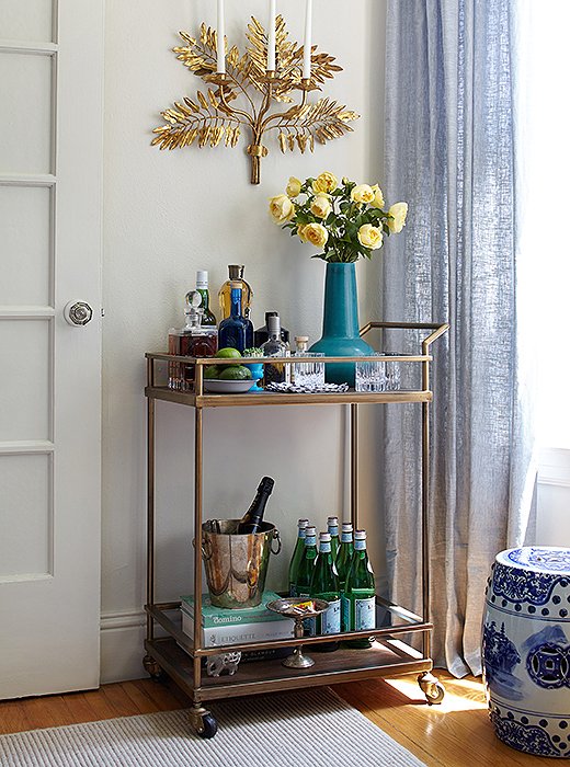 On her bar cart, Stacie stocks the essentials: citrus, spirits, champagne, and Pellegrino.
