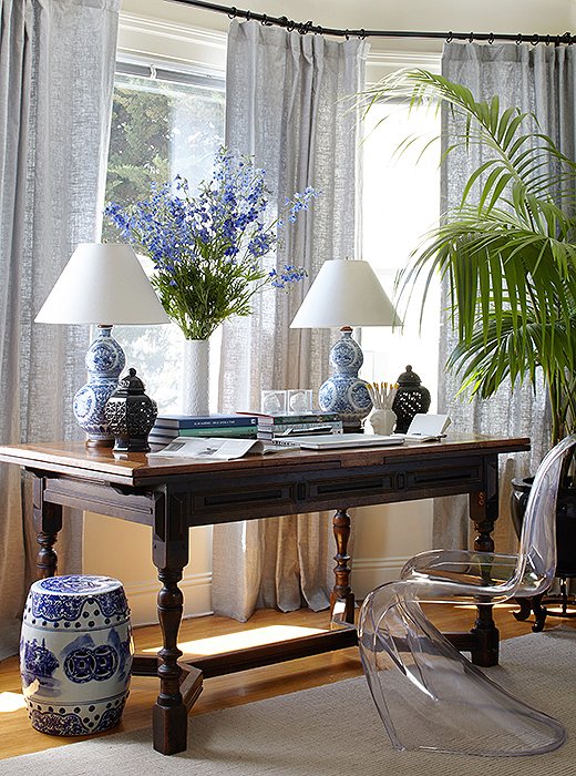 Stacie discovered her Jacobean draw-leaf table on Craigslist. “It normally sits in the bay window in our bedroom, and we often work from home, so we use it as a desk,” she says. “It expands to 10 feet, and it will fill the whole living/dining room when we rearrange the apartment for big dinner parties.”
