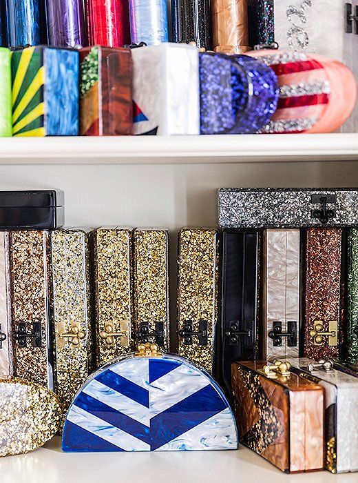 Bookshelves store archives of Edie Parker’s sparkly box clutches.

