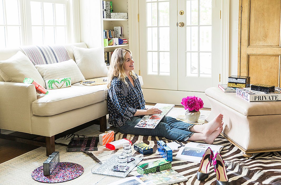 A collection of Edie Parker handbags and trays, which are emblazoned with colorful marbleized swirls and cursive lettering, are sprinkled throughout Brett’s home.
