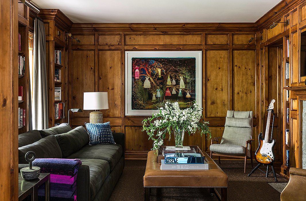 Brett’s masculine wood-paneled library is a quiet retreat for those occasions when one needs alone time. Find a similar sofa here.
