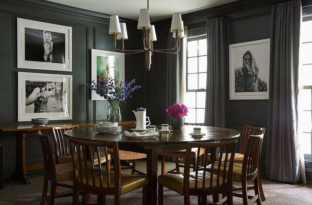 The minimal and moody gray dining room is accented with edgy photographs of Kate Moss. The Farlane chandelier by Thomas O’Brien for Visual Comfort is similar to the one here.

