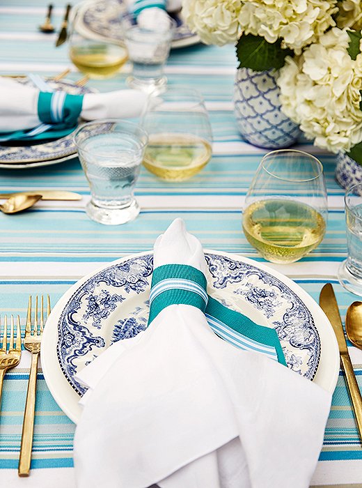 To jazz up her place settings, Guérard tied grosgrain ribbon around her dinner napkins.
