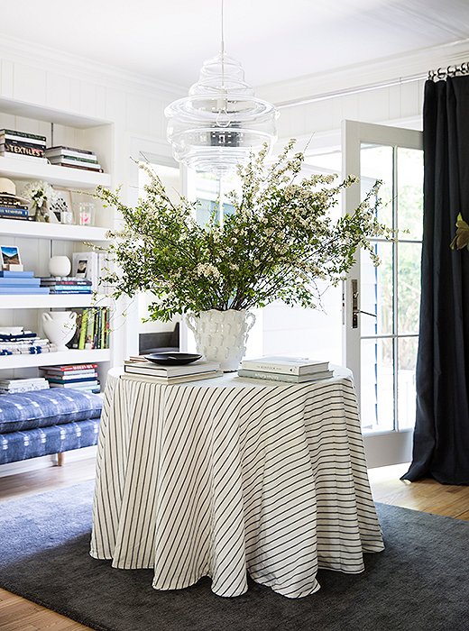 With both front and back doors, Michelle’s living room acts as a foyer of sorts. “One of the things I did when renovating was replace some windows in my living room with a set of French doors,” she says. “Then I built a blue stone patio outside so I could keep my French doors open while I’m inside and go right outside to entertain or work.”
