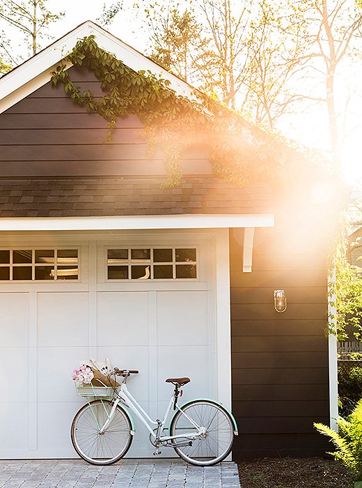 Amping up her curb appeal, she added little stone pavers and built a garage. “I think my next step is to have some more fun with the gardening, but for now basic landscaping and lanterns just clean it up a bit.”
