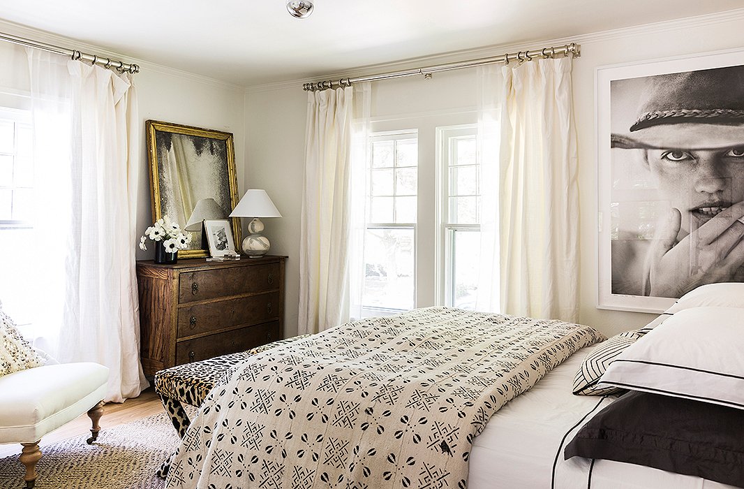 An antidote to the moody master bedroom, the guest bedroom is airy and creamy, with layers of textiles.
