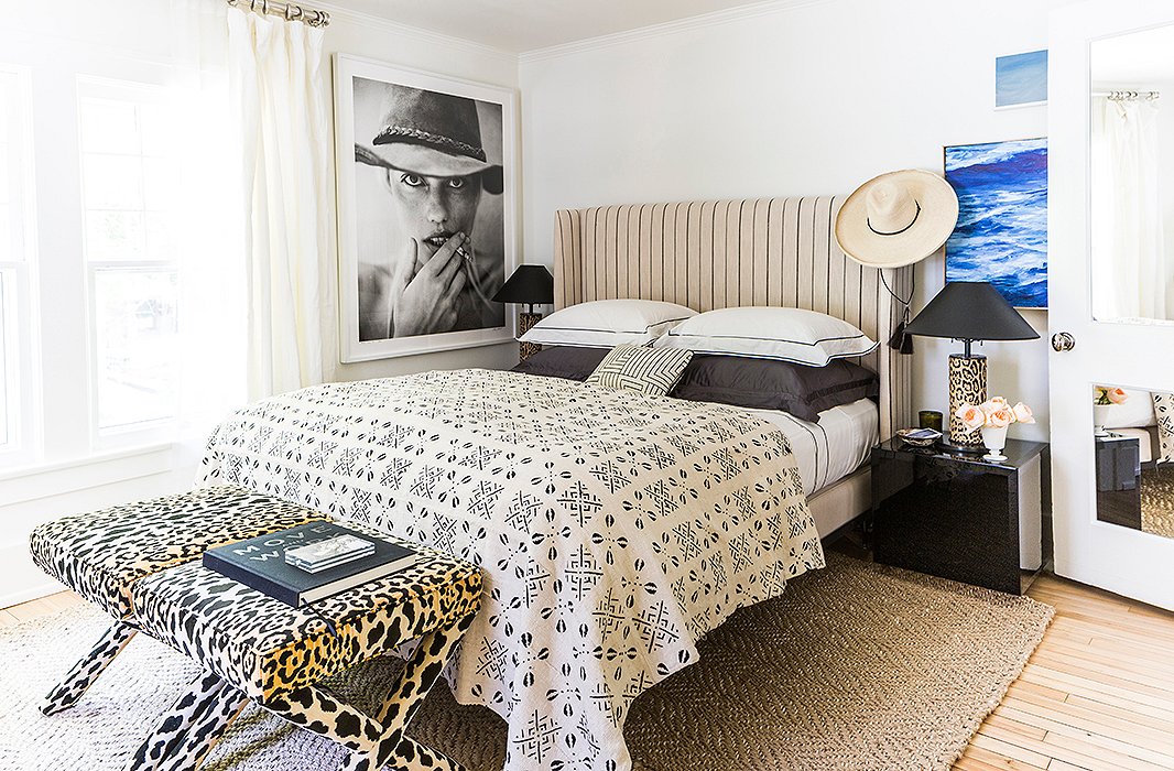 In the guest bedroom, Michelle used one of the headboard designs from her upholstery collection, a timeless cream-and-black stripe. “I went to the factory out in Chicago and spent the whole day going through different fabric books and bolts and chose all the fabrics and worked with the manufacturer to edit them down,” she tells us. “I really am happy, thrilled actually, with the quality of everything. They have a really nice hand.”
