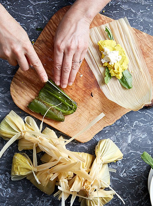 In the filling for her tamales, she uses masa harina with turmeric coconut oil, queso fresco, and jalapeño chilies.
