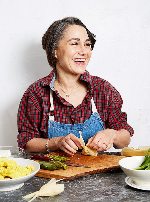 Camille preps turmeric tamales in dried corn husks.
