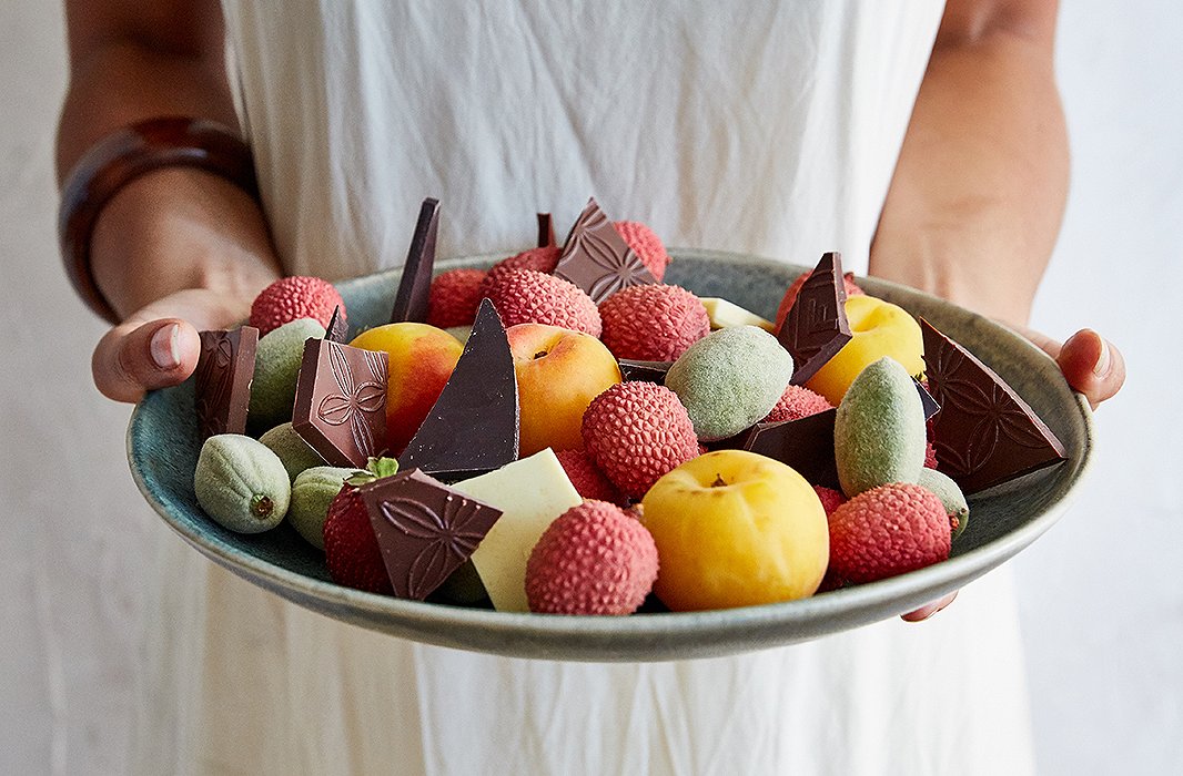 Bringing a little sweetness to the table, Camille filled a bowl with dark-chocolate shards, fresh almonds, lychees, baby apricots, and strawberries.
