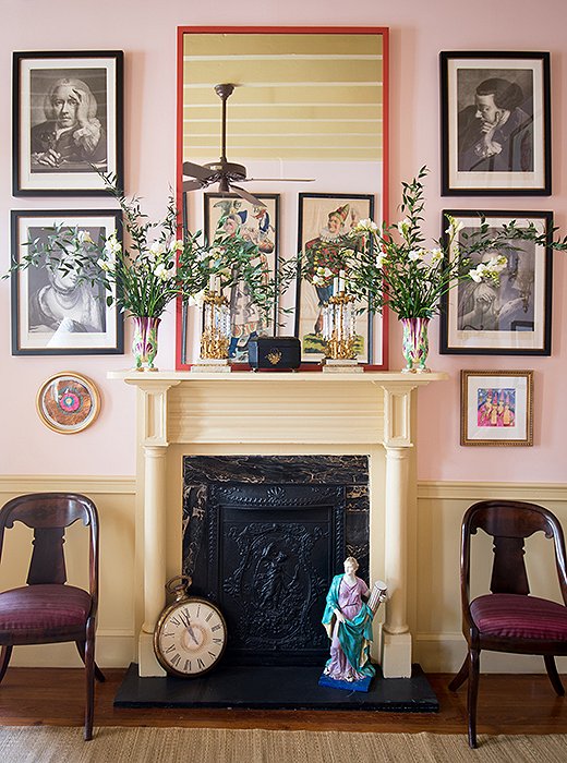 The handsome living room mantel, framed by Thomas Frye mezzotint prints, makes for a graceful home to a myriad of objects, ranging from a 19th-century sculpture to the oversize clock left over from a “Father Time” Mardi Gras costume.
