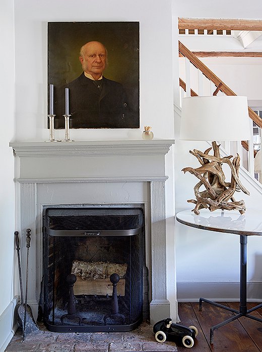 An antique oil painting hangs above the living room’s very petite fireplace.
