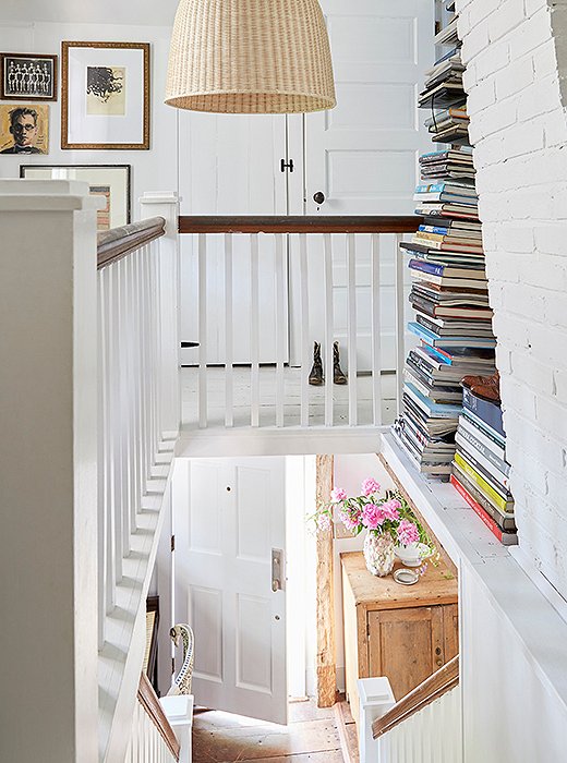 Stacks of books add personality to the stairway landing.
