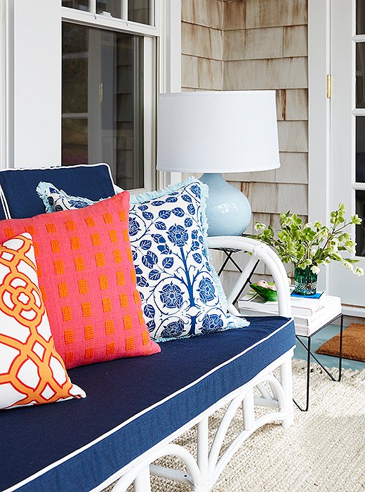 “I feel like patterns and the darker colors will let you get away with more staining, which happens a lot outside,” Estee says of her choice of navy upholstery. When decorating outdoors, “I recommend using more outdoor fabrics and not-so-precious, sturdier fabrics.”
