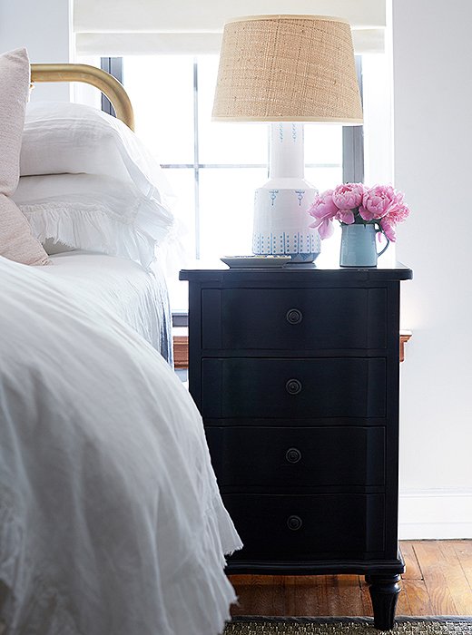 Cole loves the addition of the nightstands. “I call these my gift with purchase,” she says. “They’re tall and have three deep drawers. And with the lamps, they make such a pretty little vignette.” A shallow tray is the perfect perch for earrings or hand cream.
