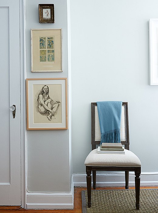 A sliver of wall becomes a pixie gallery. The charcoal drawing is by Virginia artist Lincoln Perry. The graceful Swedish-style chair plays three roles: office chair, guest seating, and solo reading spot.
