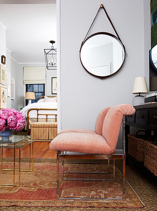 Cole originally wanted light pink walls. Fearing it might read nursery, Alex painted the room with Benjamin Moore Gray Owl and found a pair of Milo Baughman chairs in a blush hue that picks up on the pink tones in the rug.
