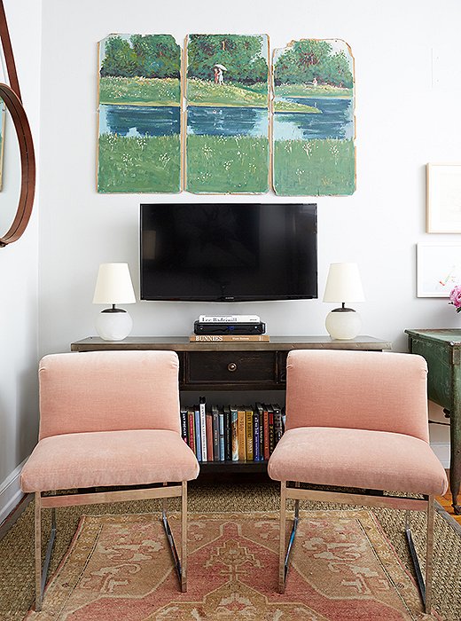 A slender console replaced a bulky armoire. “My biggest surprise was how removing the bigger storage pieces allowed for more targeted stowing and more living space,” says Cole. The triptych was found on a Boston side street.
