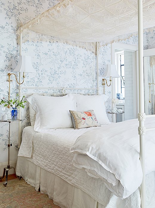 The designer tells us her favorite finds for the space are the bedside tables in the master bedroom: “There’s really no space for a queen bed and two tables, so they’re just drink tables. They’re so tiny. They’re so cute. They have a scalloped edge and are nickel with little brass threads that lift them up or down so you pick the height.”
