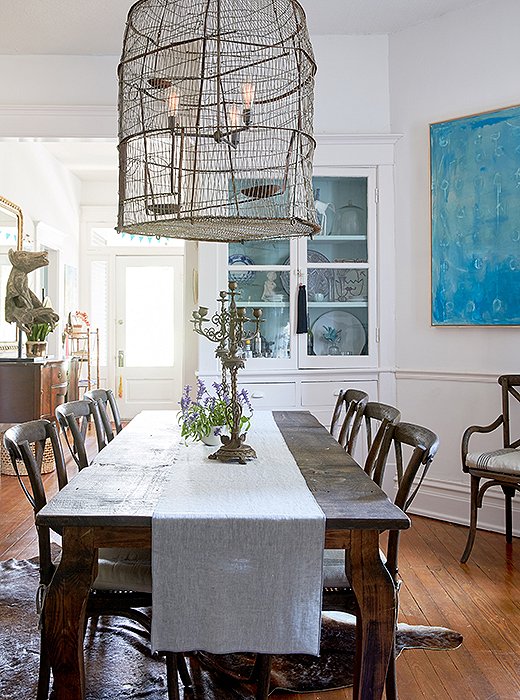 The blue painting in Kate’s dining room is by artist friend Addie Chapin. Her art collection consists largely of “pieces my husband and I found together on a trip, pieces friends have made, or gifts to one another,” she says. “We love to give art to each other to mark special moments in life.”
