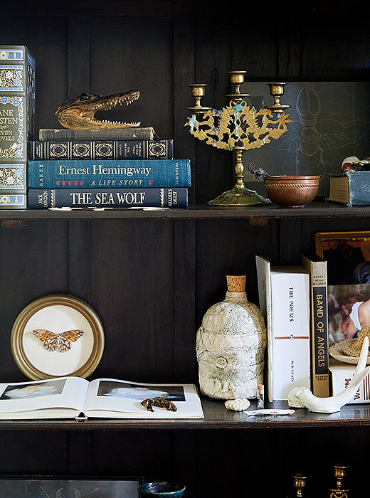 Kate’s shelves are beautifully styled with vintage books, small paintings, antique candleholders, and small works of art.
