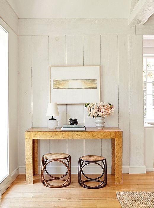 “In the living room, the burl-wood console and mismatched Thonet ottomans bring a lot of texture and character,” Alex says. “I love that we didn’t use a matching pair [of stools]. It helps you remember that nothing is perfect.”
