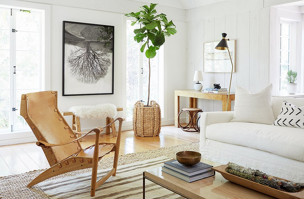 The house was a blank canvas for The Studio, but Jenni had set aside a few pieces from her previous home that she thought might end up working in the space. “Jenni had a great collection of vintage leather chairs that I definitely wanted to incorporate,” Alex tells us. “We thought a supersimple slipcovered sofa in white would work well with them, and we also brought in a lot of vintage pieces to pull the look together.” 