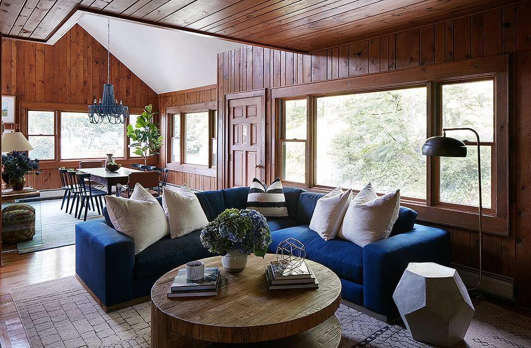 The color palette of rich blues continues into the adjacent movie room, where the family gathers for screenings or to sit around the fireplace during cooler months. Here it was all about soft textiles and cozy textures, from the Moroccan rug to the plush sectional. Find the side table here.
