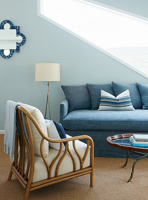 The sitting area’s clever sofa has a trundle bed that pops out to sleep two people, while the vintage coffee table and pillows make the space feel lived-in.
