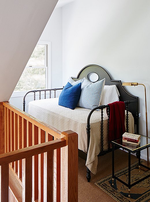 Every square foot of the house was maximized to sleep as many people as possible. Even the landing can host overflow guests: The daybed, side table, and floor lamp create an extra bedroom in an often-underutilized space.
 
 
 
