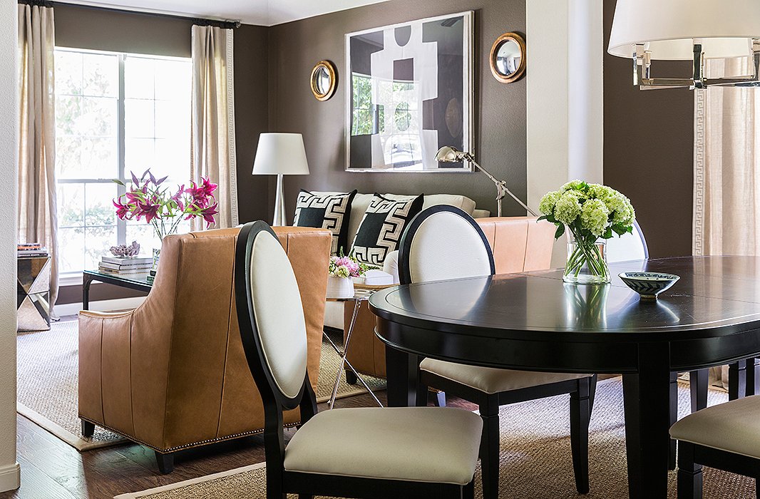 The dining area, just off the living room, reveals the home’s prevailing palette. “I use black, gray, chocolate brown, and then a few pops of color here and there.” The couple bought the dining table and chairs at a local showroom just before they were married.
