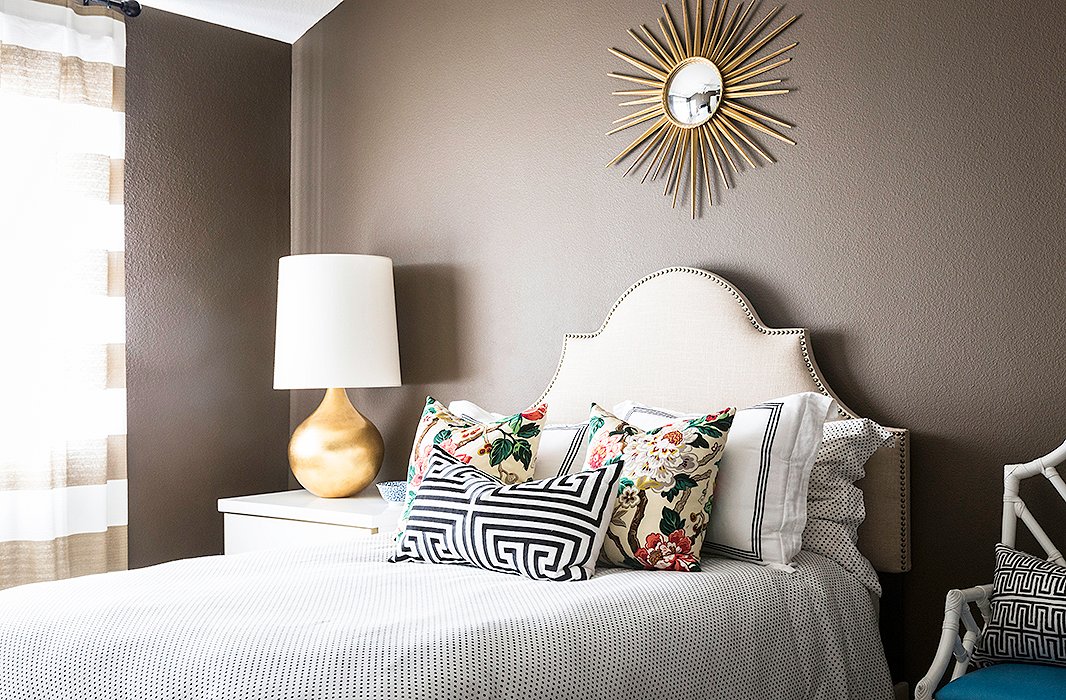 Paloma likes guests to feel “comfortable and happy.” Not a stretch in this pretty guest suite. An upholstered headboard is the background for a rich mix of bedding and pillows. She pairs a polka-dot duvet and shams with hotel linens and a pair of chinoiserie pillows with a peony print. A Greek key lumbar pillow finishes the look.
