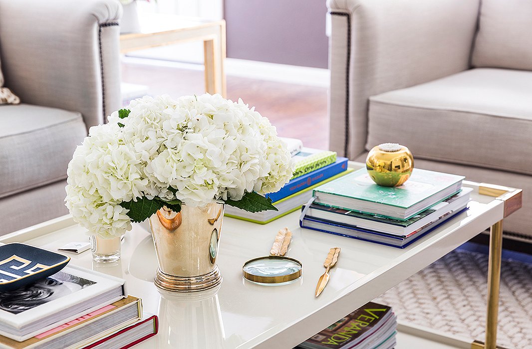 “I love this [Bernhardt] coffee table. The contrast of the cream lacquer and brass hardware is really beautiful,” says Paloma. Her styling tip? “I think a good mix of books, a few carefully chosen accessories, and fresh flowers are always a winning combination.”

