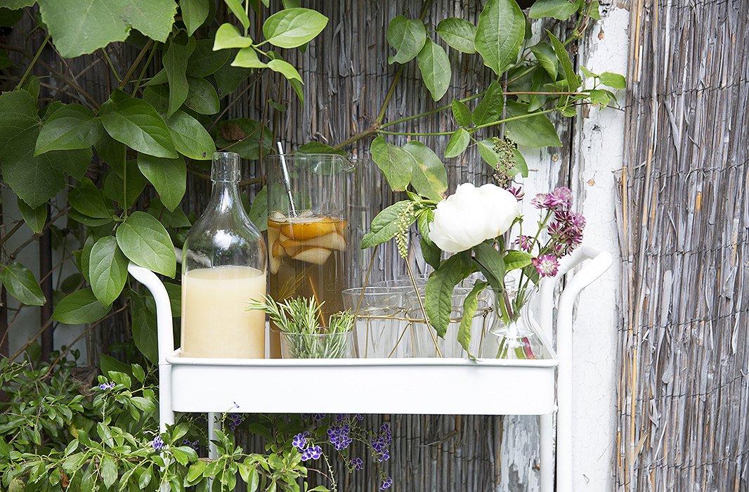 A humble pitcher holds a pretty mix of peonies and wildflowers.
