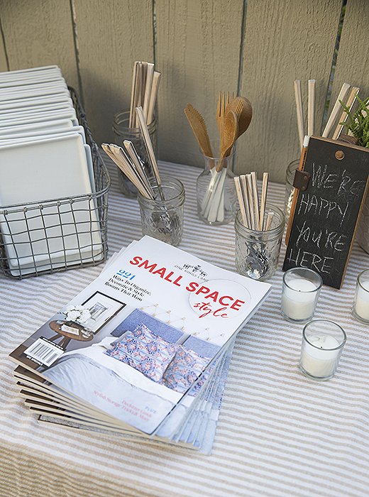 A cheerful sign, votive candles, and an abundance of plates and flatware make guests feel as if they live here too.
