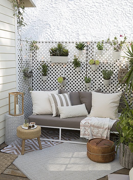 The porch, just off the kitchen, has a hanging garden and plush seating. “People love this spot,” Whitney says. “It’s connected to the house, but it still feels like a nook where you can have a one-on-one conversation.”
