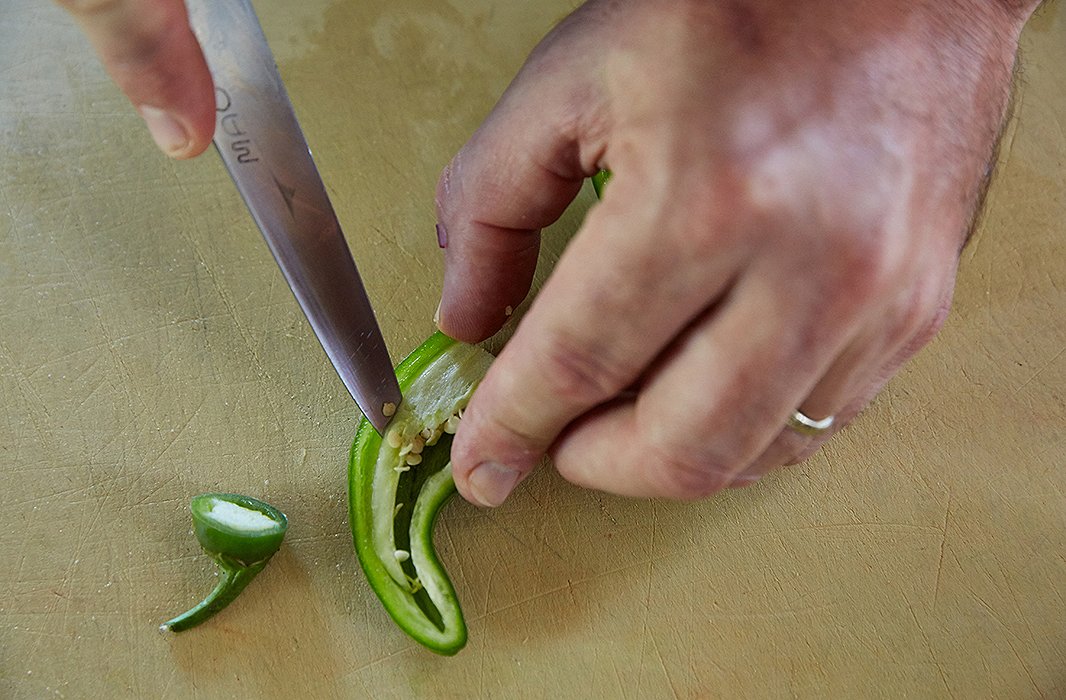 The hot peppers receive special treatment: They get cut into 1/8-inch cubes rather than quarter-inch. The French term for this teensy cut is a brunoise. Of the hot peppers’ role, Greg explains, “You’re looking for the vegetable flavor in these, not the heat,” so take out the heat-carrying seeds.
