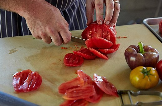 Cut “petals” around the peeled tomatos—this will become what you slice and dice into quarter-inch cubes. The remaining seeds and juice all go into the purée.
