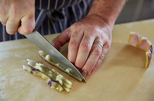 Flatten the opened circle, and cut the pepper lengthwise into quarter-inch slices. Then turn and dice to get your quarter-inch cube.
